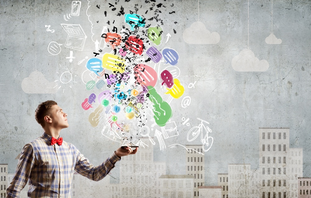 Young man with mobile phone and colorful chat icons